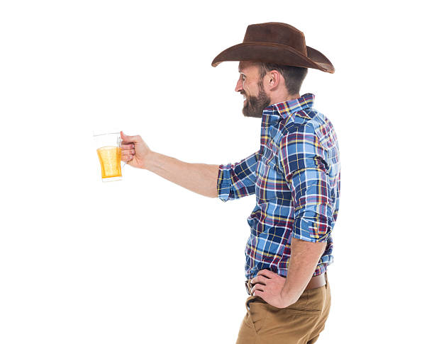 istock Smiling cowboy holding drink glass 626372396