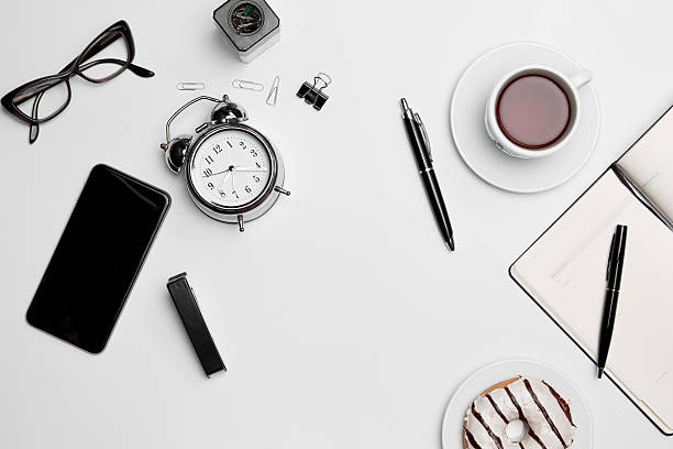 istock Office desk table with cup, supplies, phone on white background 626373988