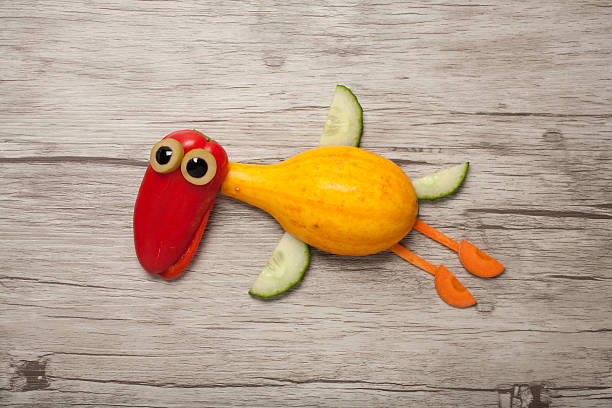 istock Flying duck made of vegetables on wooden background 626374524