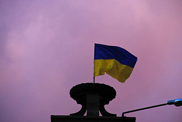 istock Flag of Ukraine against sky at sunset 626374702