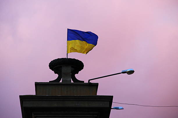istock Flag of Ukraine against sky at sunset 626374706