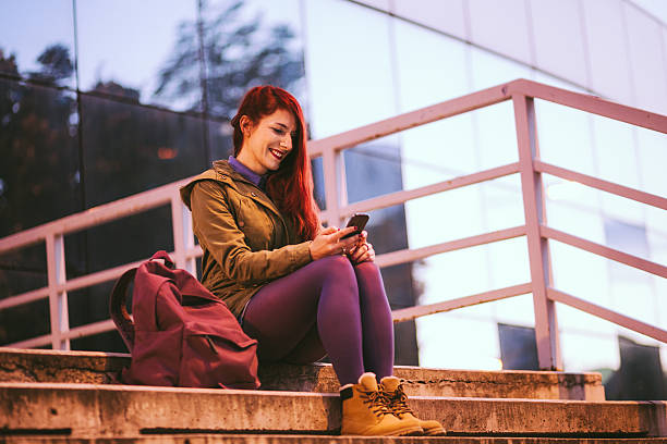 istock Happy Redheaded Girl Messaging 626384890