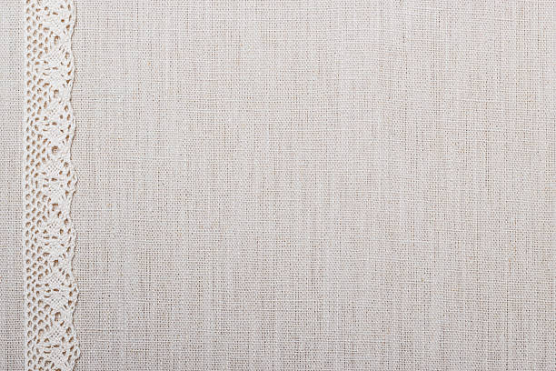Lace ribbon on linen cloth background