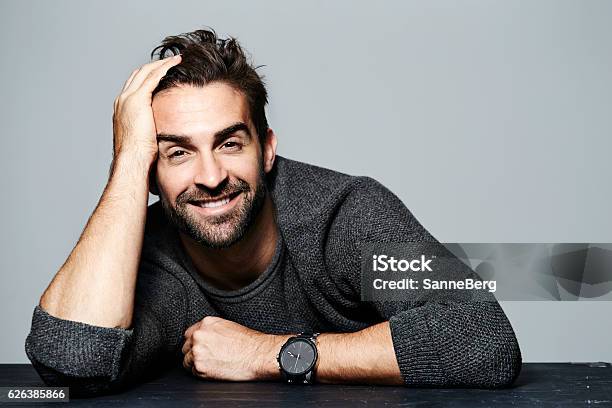 Smiling Guy In Grey Stock Photo - Download Image Now - Hand In Hair, Wristwatch, Portrait