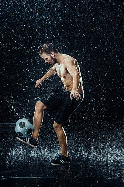 istock Water drops around football player 626387584