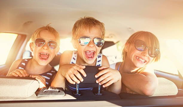 istock Kids having fun in car on a road trip 626387592