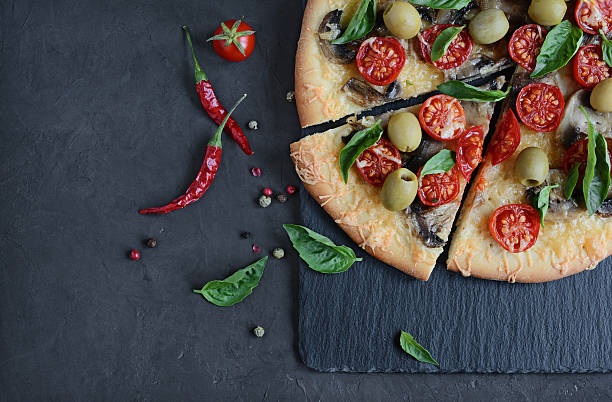 istock Mushroom pizza with cherry tomatoes and basil 626394244