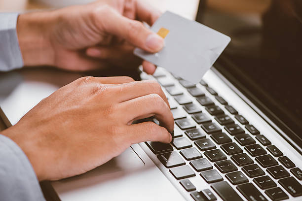 istock Hands holding plastic credit card and using laptop 626394362