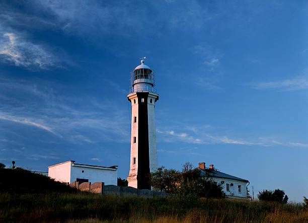 istock Tower of lighthouse  on a background of clouds 626395288