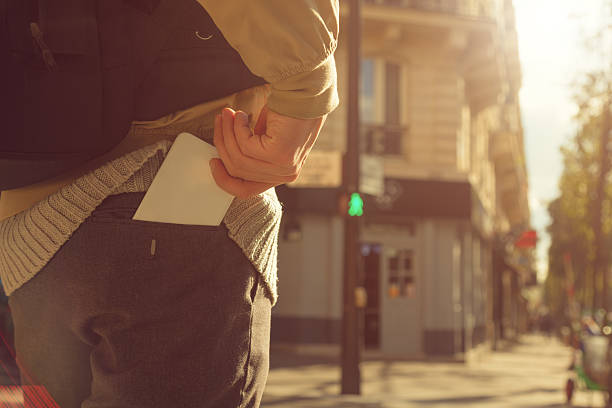 Man holding cellphone in pocket.