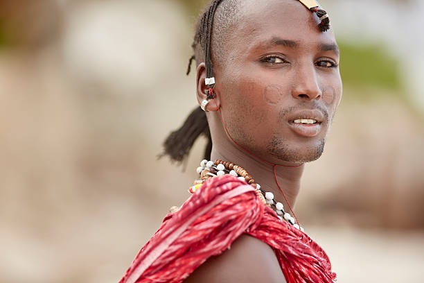 Elegant Maasai man standing under Zanzibar's palm trees.