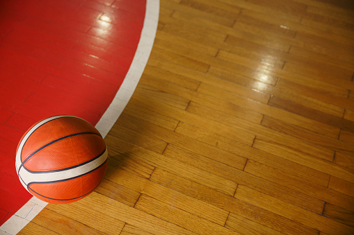Basketball ball on court floor, parquet.  Basketball  background with copy space.