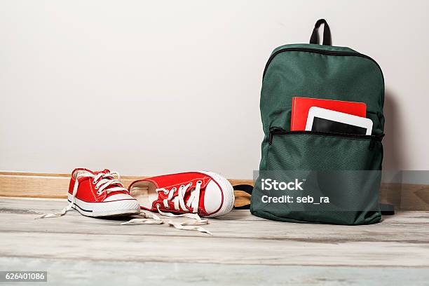 Red Sneakers With School Bag On Wooden Background Stock Photo - Download Image Now - Backpack, Flooring, Bag