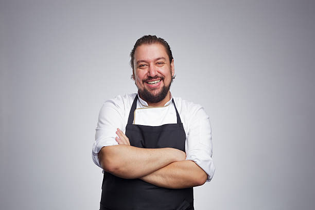 istock Pleased chef looking confidently at the camera and laughing. 626401170