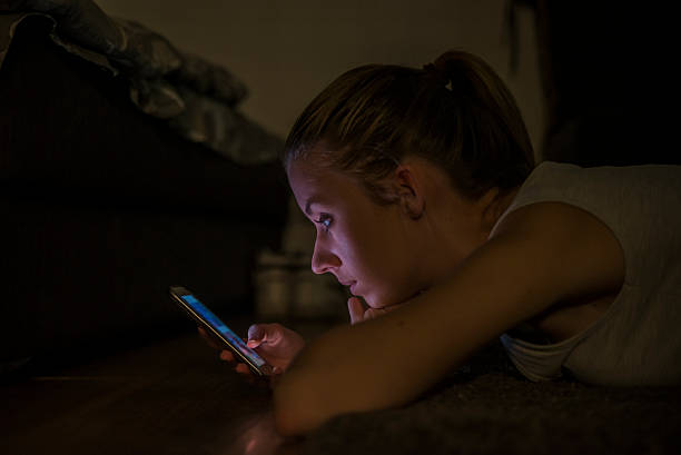 istock Pretty brunette texting with her smartphone at home 626401442