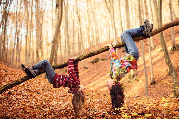 mother with daughter in autumn wood - trees hanging imagens e fotografias de stock