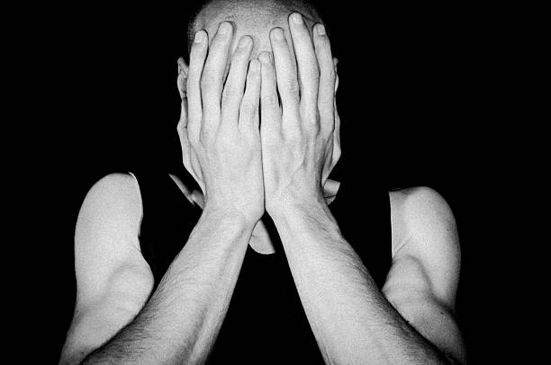 istock Depressed man cover his face with his hands 626403348