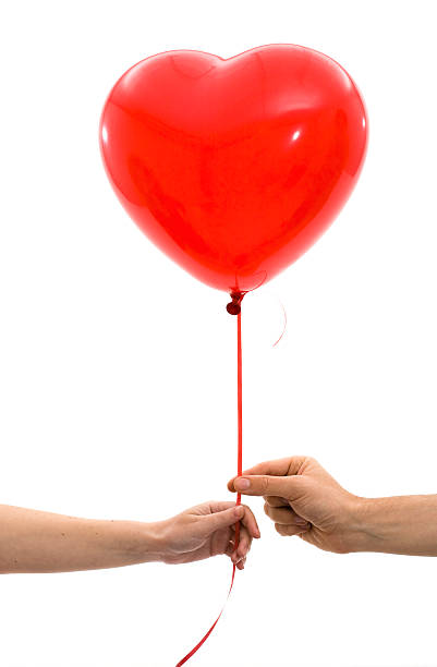 condividere l'amore - men giving balloon women foto e immagini stock