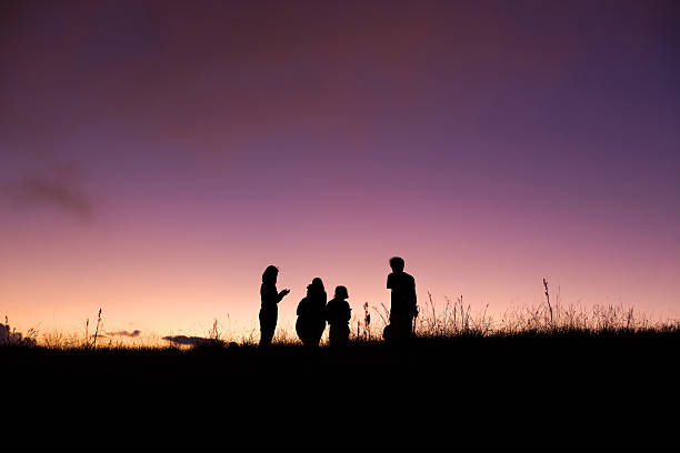 istock silhouette people on top of mountain 626409258