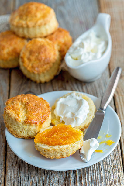 istock Scones with orange jam and whipped cream for breakfast. 626411560