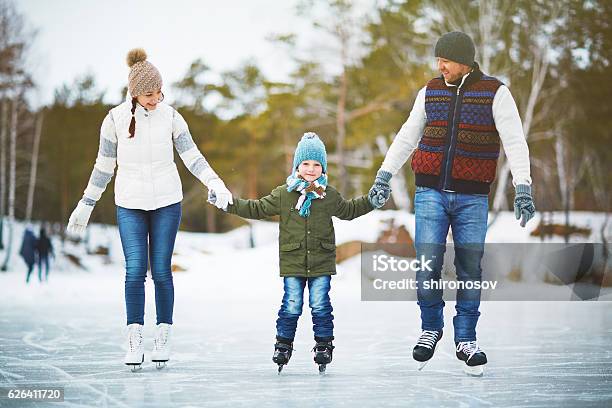 Joyful Family Of Skaters Stock Photo - Download Image Now - Ice-skating, Family, Outdoors