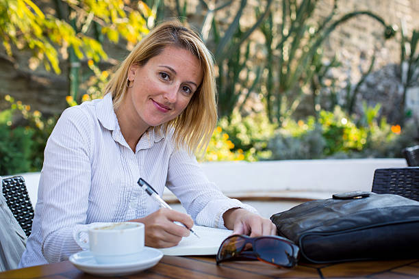 istock Cheerful business woman reading a book 626413334