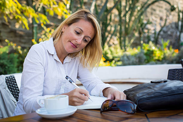 istock Cheerful business woman reading a book 626413754