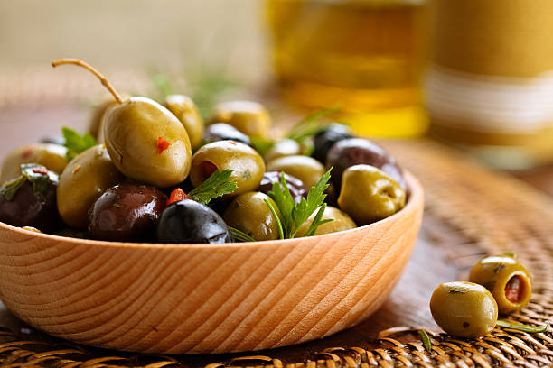 marinated olives with herbs. - olive green olive stuffed food imagens e fotografias de stock