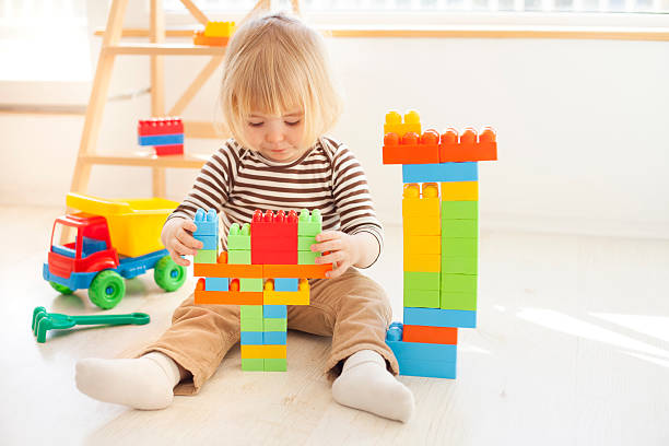 istock Little child playing with colorful plastic blocks 626421406