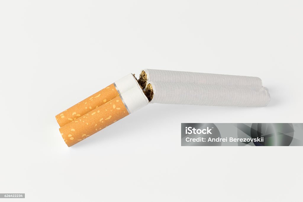 two cigarettes in a shotgun two cigarettes in a refracted shotgun on a white background Addiction Stock Photo