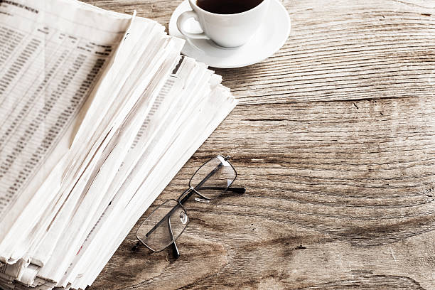 istock Newspaper on wooden table 626422438