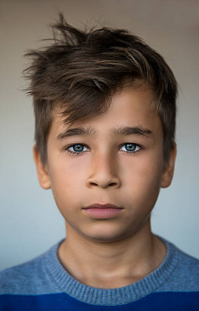istock Portrait of little boy with blank expression 626422756