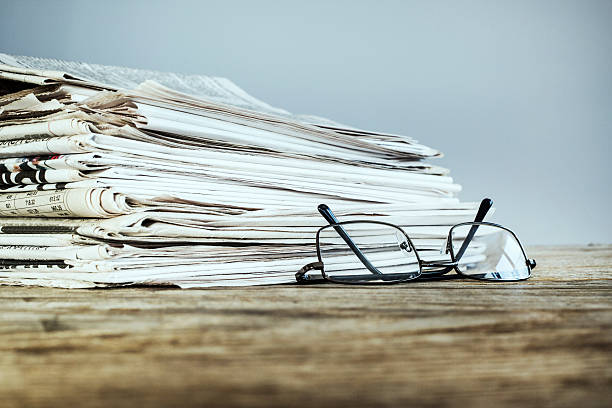 istock Newspaper on wooden table 626422760