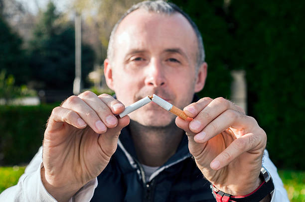 istock Gesture for quit smoking, Anti Smoking,  male hand crushing cigarette 626424670