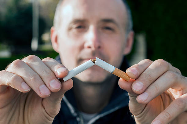 istock Gesture for quit smoking, Anti Smoking,  male hand crushing cigarette 626424756