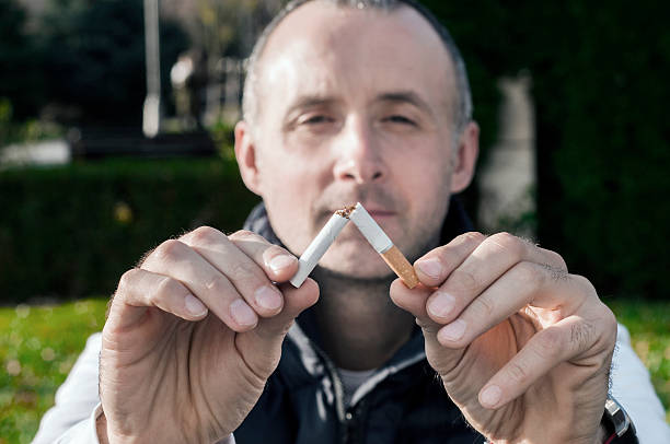 istock Gesture for quit smoking, Anti Smoking,  male hand crushing cigarette 626426140