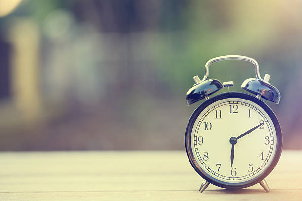 istock Retro alarm clock on wooden table, vintage style 626426208