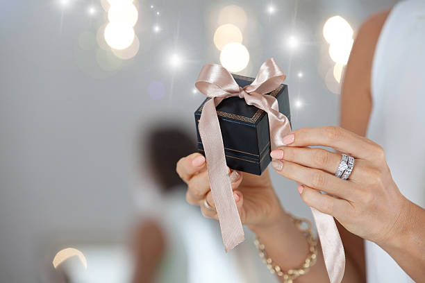istock Female hands holding small elegant gift with ribbon. 626426284