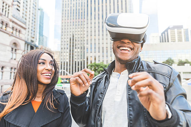 istock Woman and man smiling as he tries virtual reality headset 626426334
