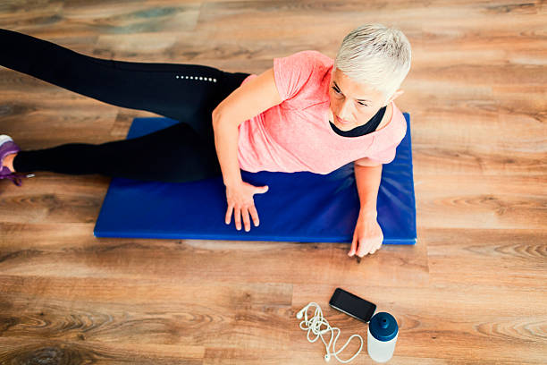 Mature Woman Exercising In Gym.