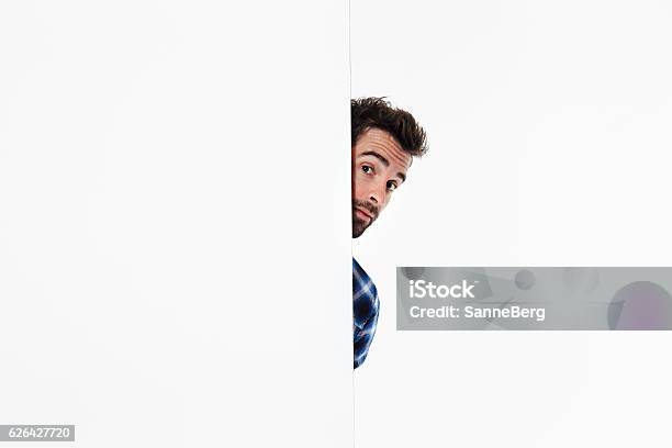 Shy Guy Peering Stock Photo - Download Image Now - Peeking, People, Curiosity