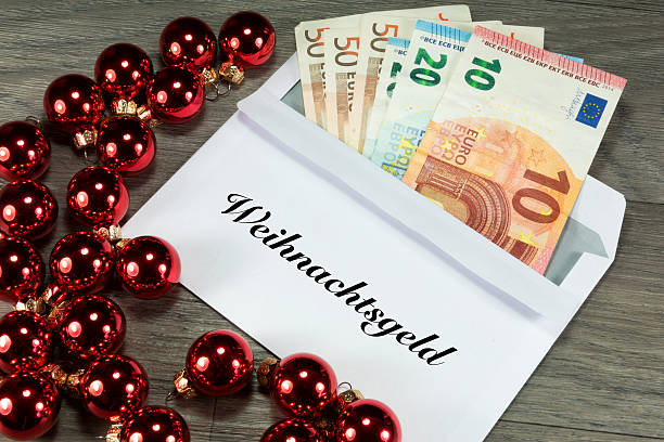 Christmas bonus in envelope Christmas bonus, envelope and Christmas baubles euro bill in a christmas ornament stock pictures, royalty-free photos & images