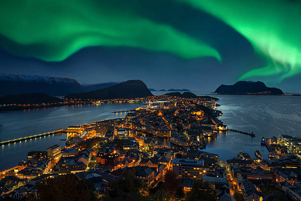 Northern lights - Green Aurora borealis over Alesund, Norway Green Aurora borealis over Alesund, Norway.  geomagnetic storm photos stock pictures, royalty-free photos & images