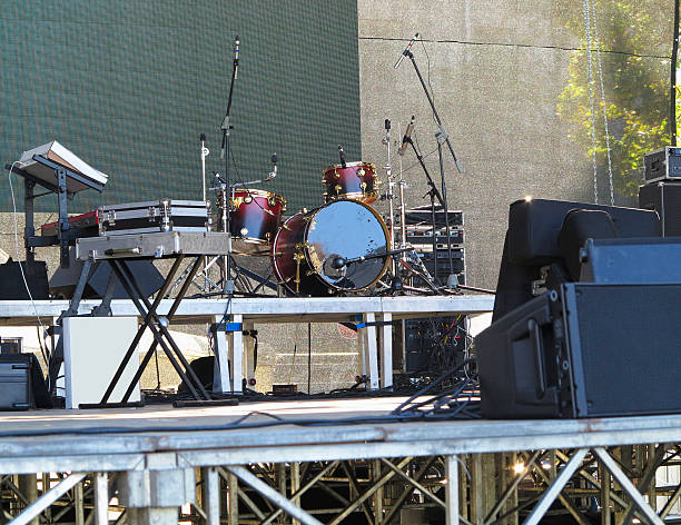 istock Drum set, microphones and speakers on stage 626429878