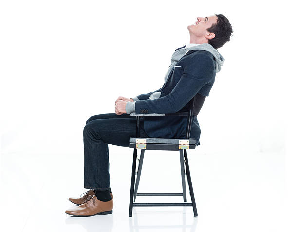 istock Smiling man on chair and looking up 626434670