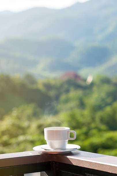 istock White cup of hot coffee on balcony with natural. 626435894
