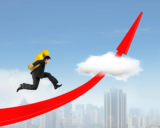 istock Man carrying dollar sign running on red arrow up graph 626437146
