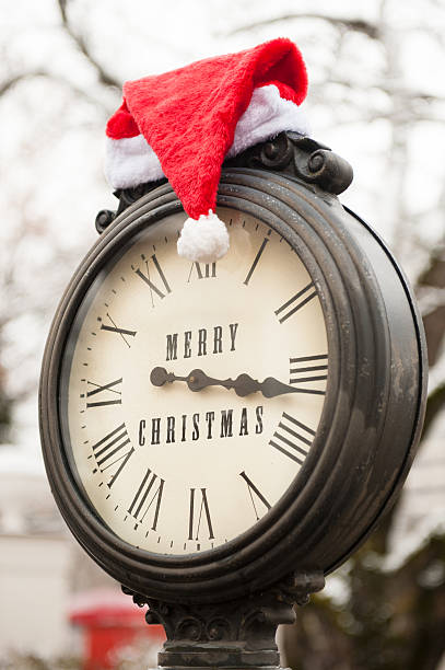 istock vintage clock with santa hat and words Merry Christmas 626438162