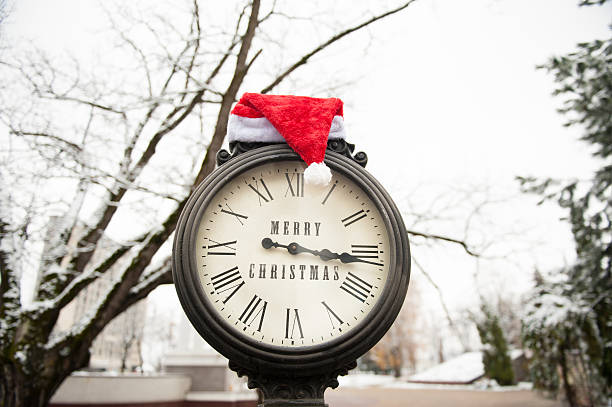 istock vintage clock with santa hat and words Merry Christmas 626438190