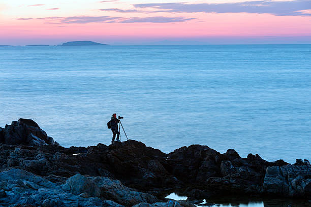 Silhouette of Photographer With Camera and Tripod